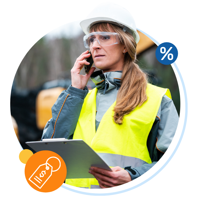 Woman worker in PPE holding a clipboard and coordinating work over the phone